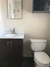 3313 Southeast 3rd Street Pompano Beach, FL 33062 - Photo 10 of 22 a white toilet sitting next to a bathroom sink