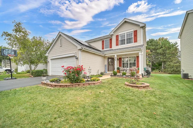 a front view of a house with yard and outdoor seating