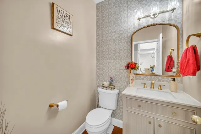 a bathroom with a sink mirror and toilet
