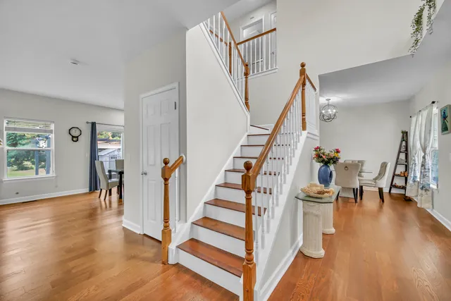 a view of entryway and hall with wooden floor