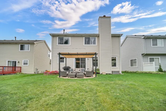 a front view of house with yard and outdoor seating