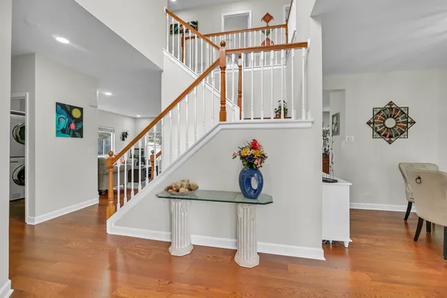 a view of entryway and hall with wooden floor