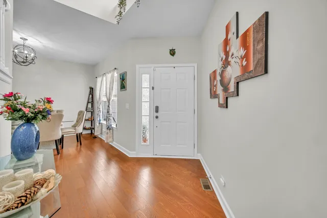 a view of an entryway with wooden floor