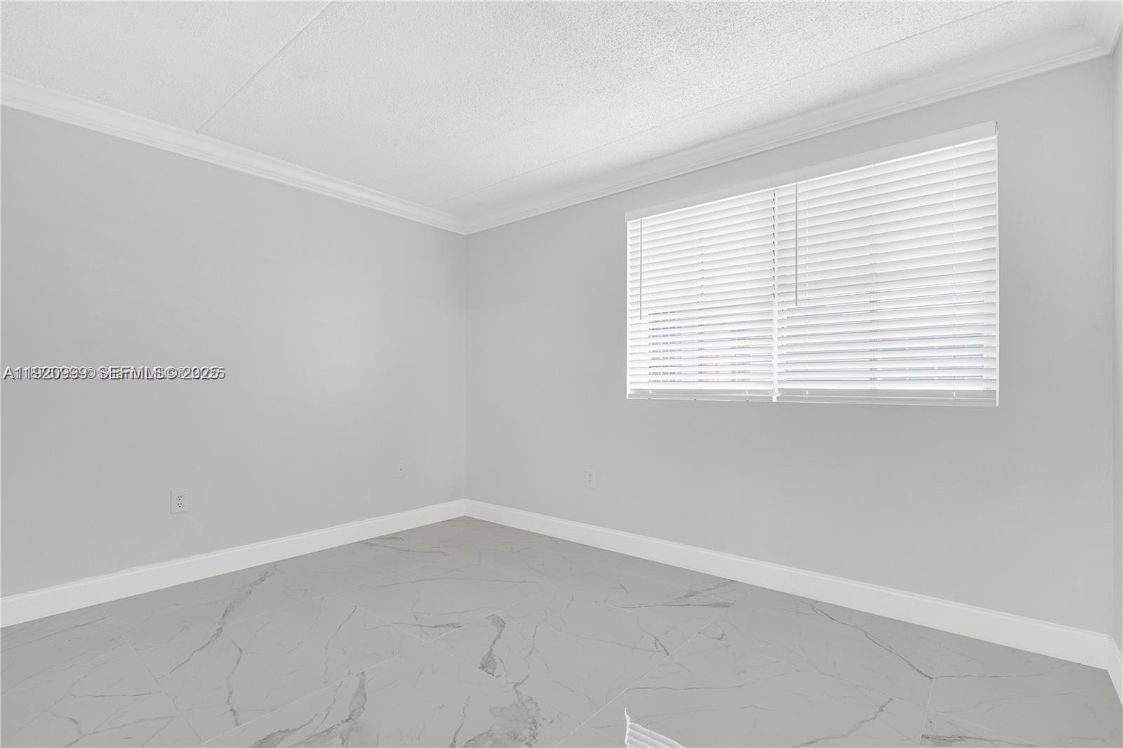 6135 Northwest 186th Street, Unit 202 Hialeah, FL 33015 - Photo 11 of 21 an empty room with a window