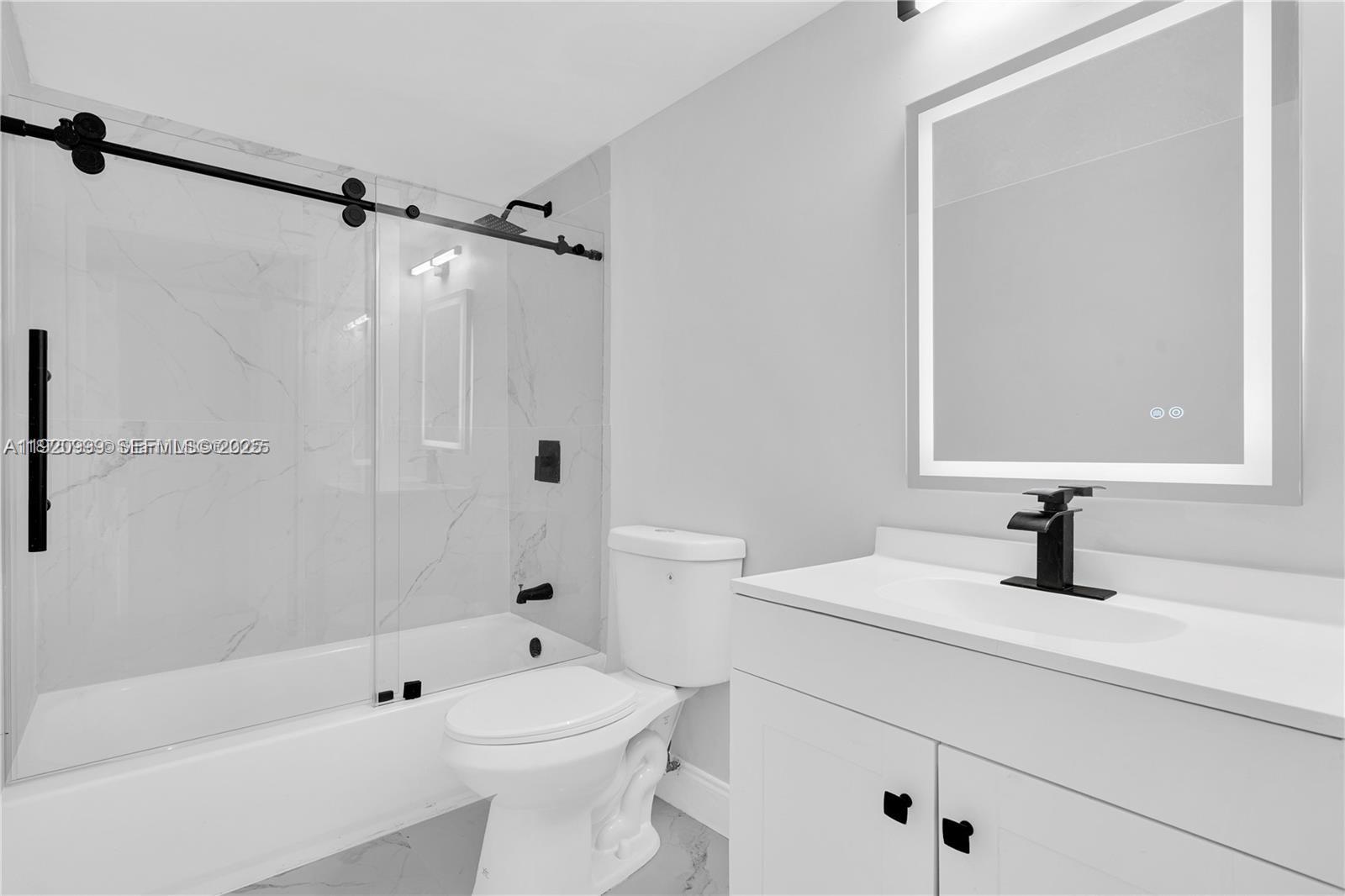 6135 Northwest 186th Street, Unit 202 Hialeah, FL 33015 - Photo 16 of 21 a bathroom with a sink a toilet and shower
