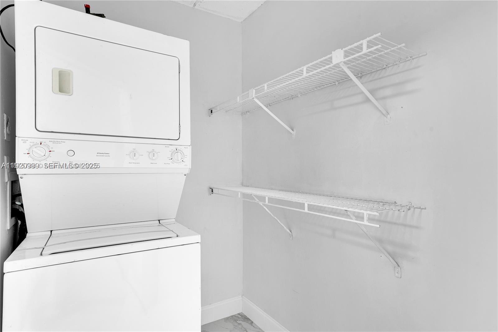 6135 Northwest 186th Street, Unit 202 Hialeah, FL 33015 - Photo 17 of 21 a utility room with dryer and washer