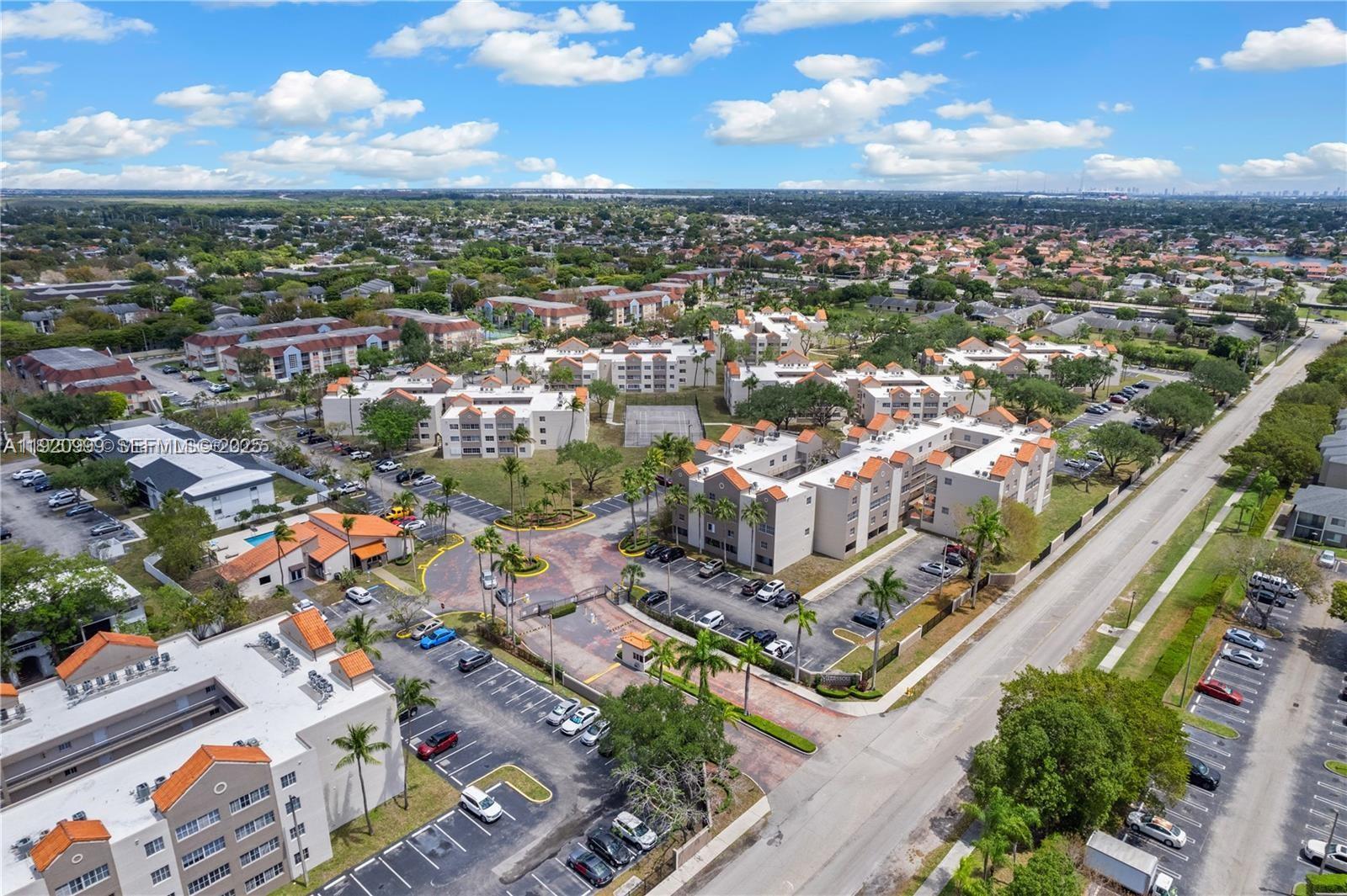 6135 Northwest 186th Street, Unit 202 Hialeah, FL 33015 - Photo 18 of 21 an aerial view of residential houses with outdoor space