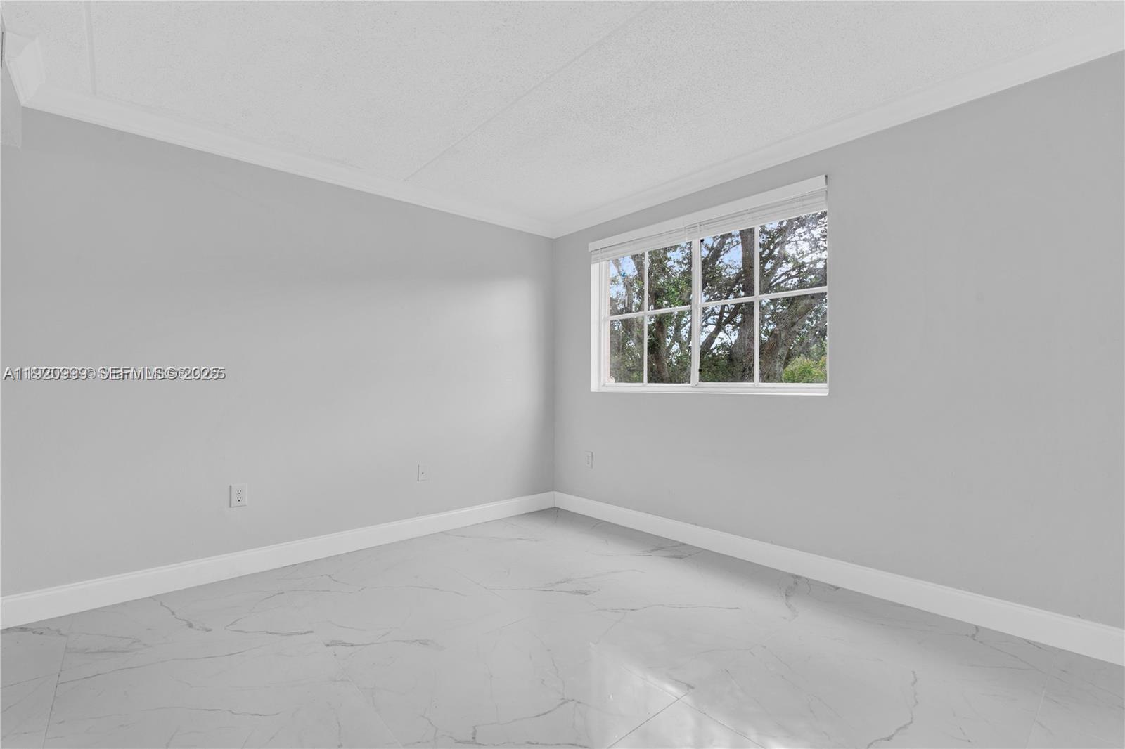6135 Northwest 186th Street, Unit 202 Hialeah, FL 33015 - Photo 5 of 21 an empty room with windows