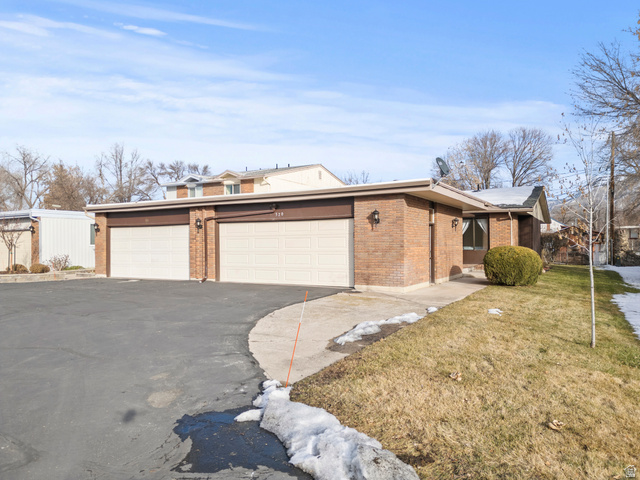 320 North 150 West Logan, UT 84321 - Photo 19 of 22 View of front of property featuring asphalt driveway, a front lawn, and brick siding