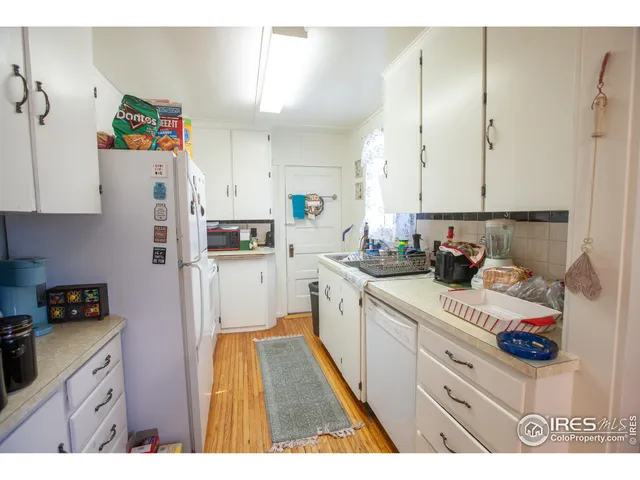 a kitchen with refrigerator and cabinets