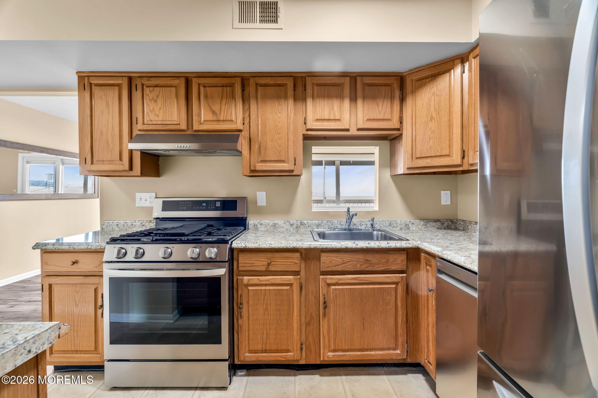 120 South Concourse, Unit 310 Neptune Township, NJ 07753 - Photo 11 of 44 a kitchen with granite countertop wooden cabinets stainless steel appliances and a sink