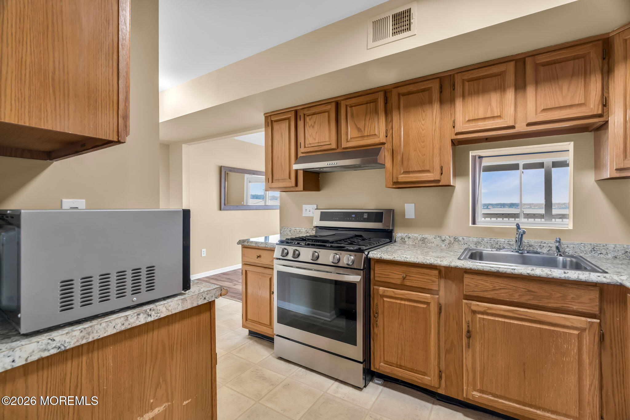 120 South Concourse, Unit 310 Neptune Township, NJ 07753 - Photo 12 of 44 a kitchen with stainless steel appliances granite countertop a stove a sink and a microwave