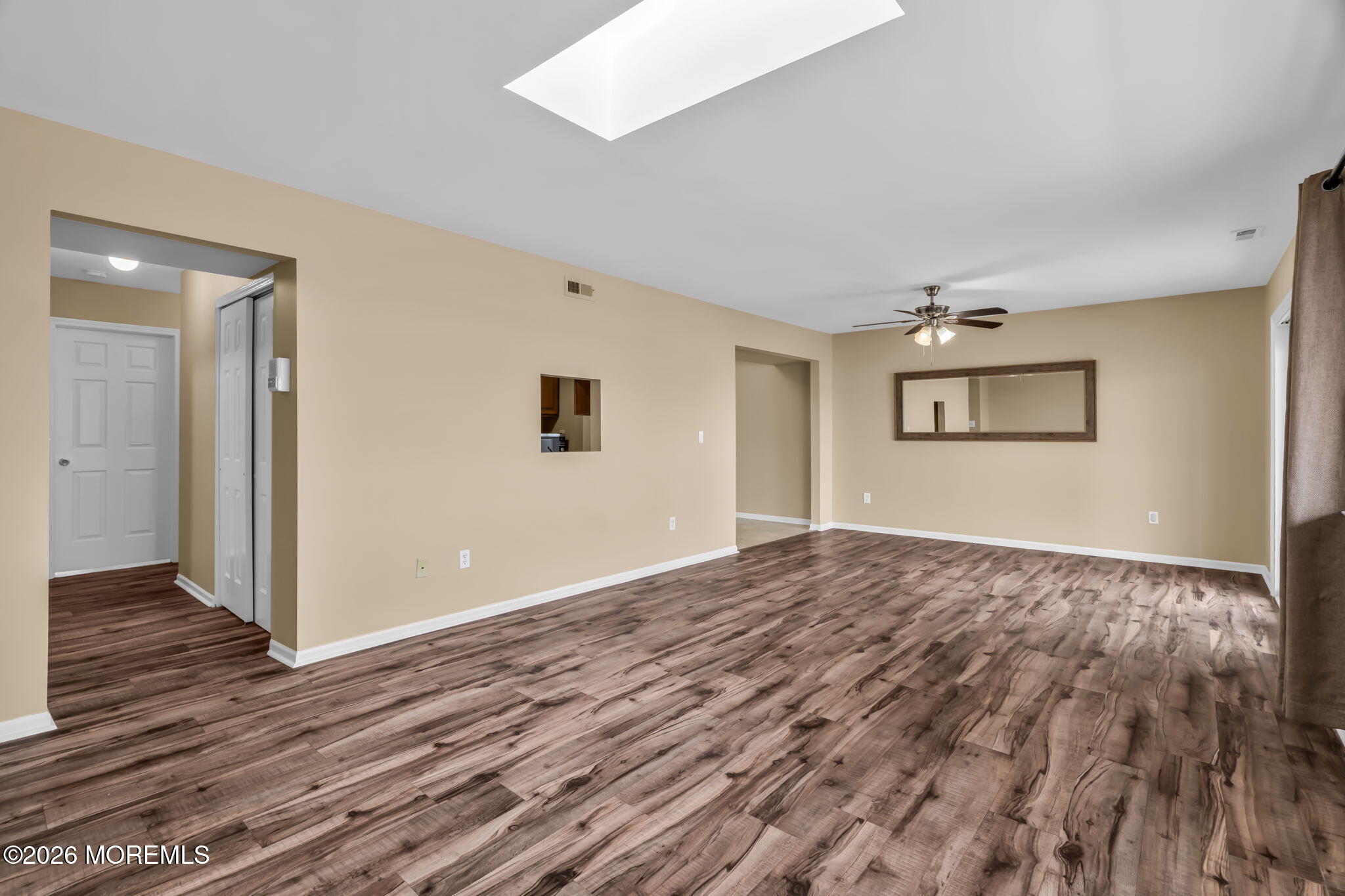 120 South Concourse, Unit 310 Neptune Township, NJ 07753 - Photo 5 of 44 an empty room with wooden floor and windows
