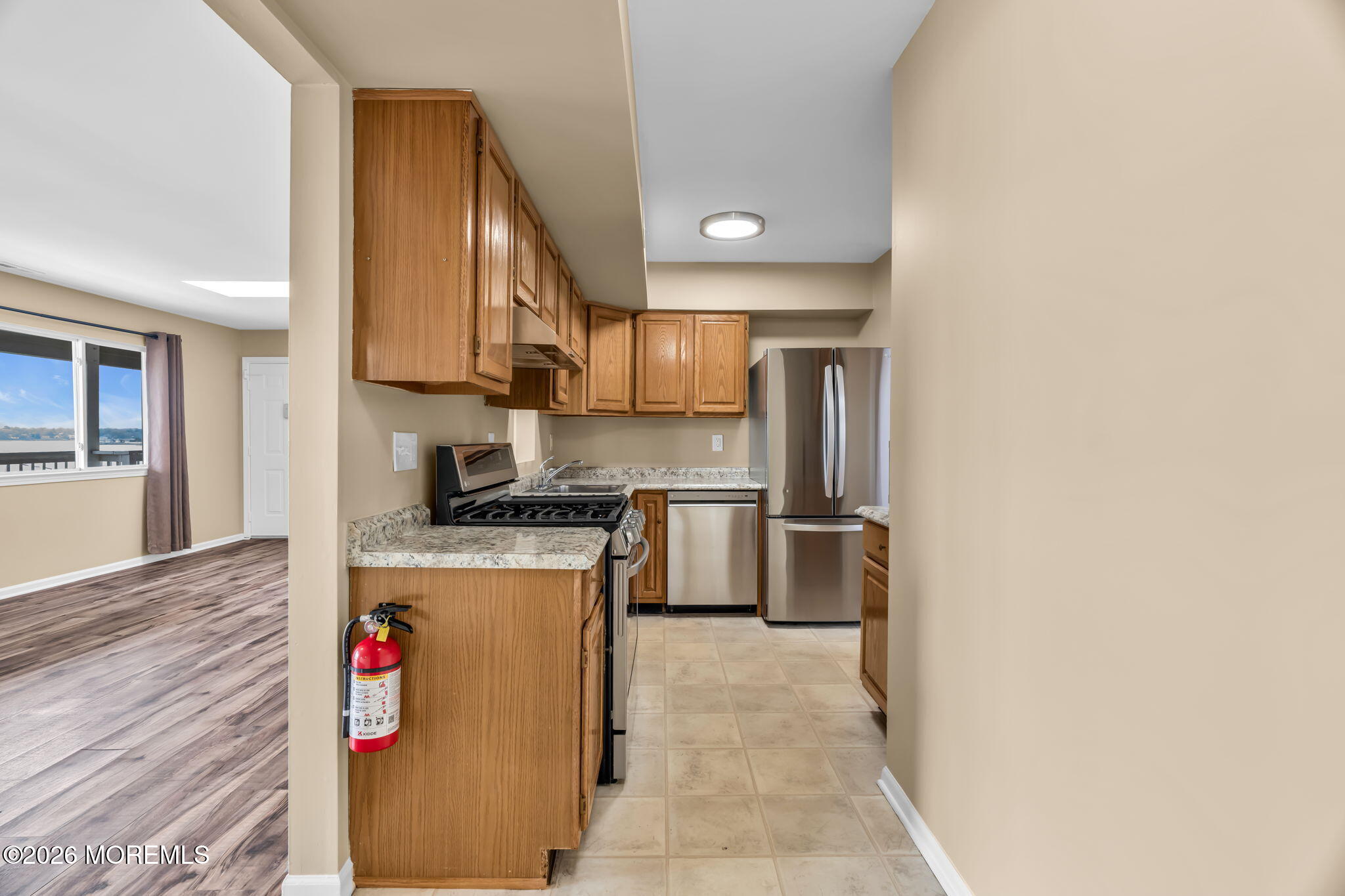 120 South Concourse, Unit 310 Neptune Township, NJ 07753 - Photo 10 of 44 a kitchen with stainless steel appliances granite countertop a refrigerator a stove and a sink with wooden floor