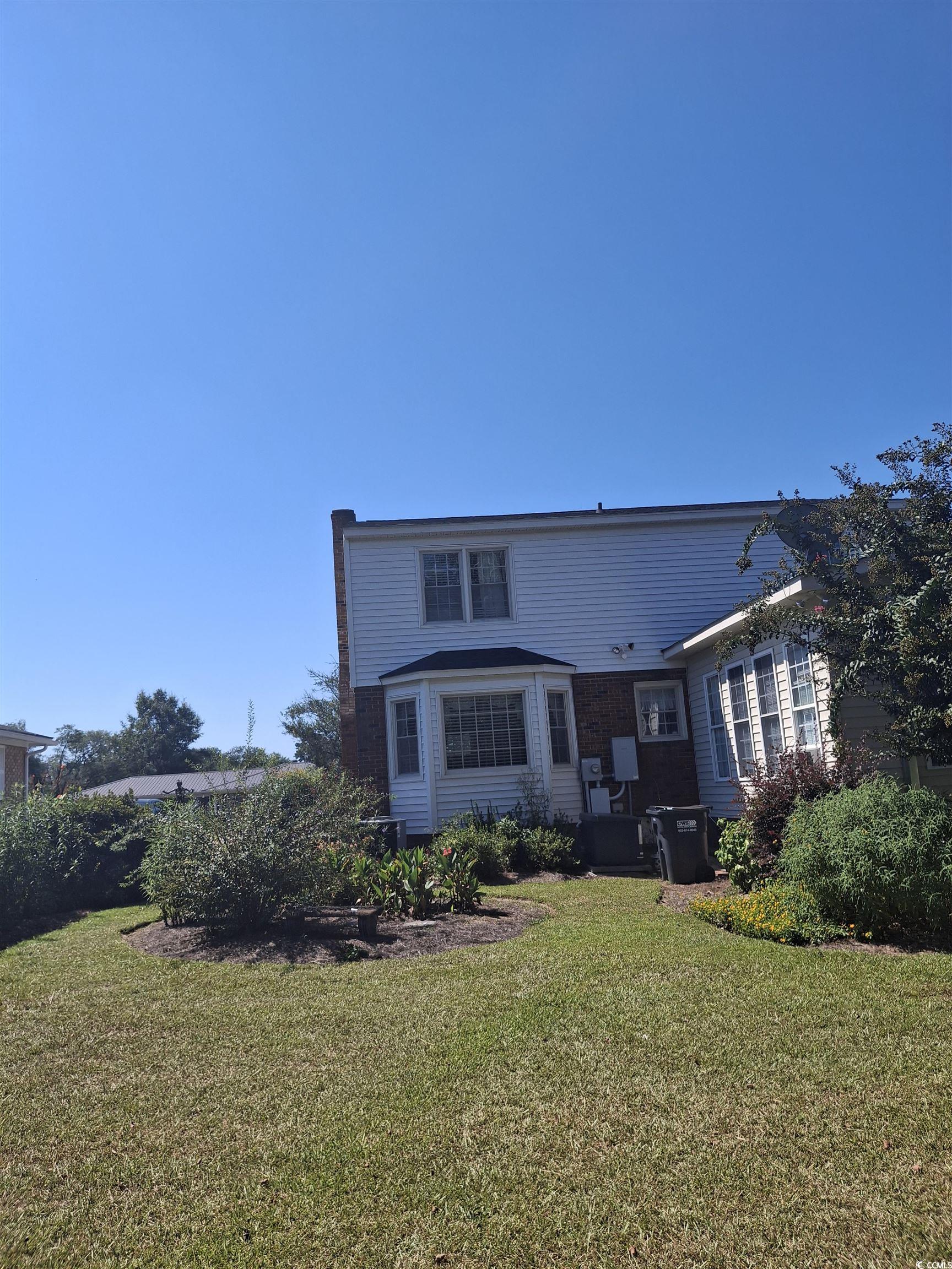 410 Devon Road Marion, SC 29571 - Photo 14 of 38 Back of house featuring a yard and a patio