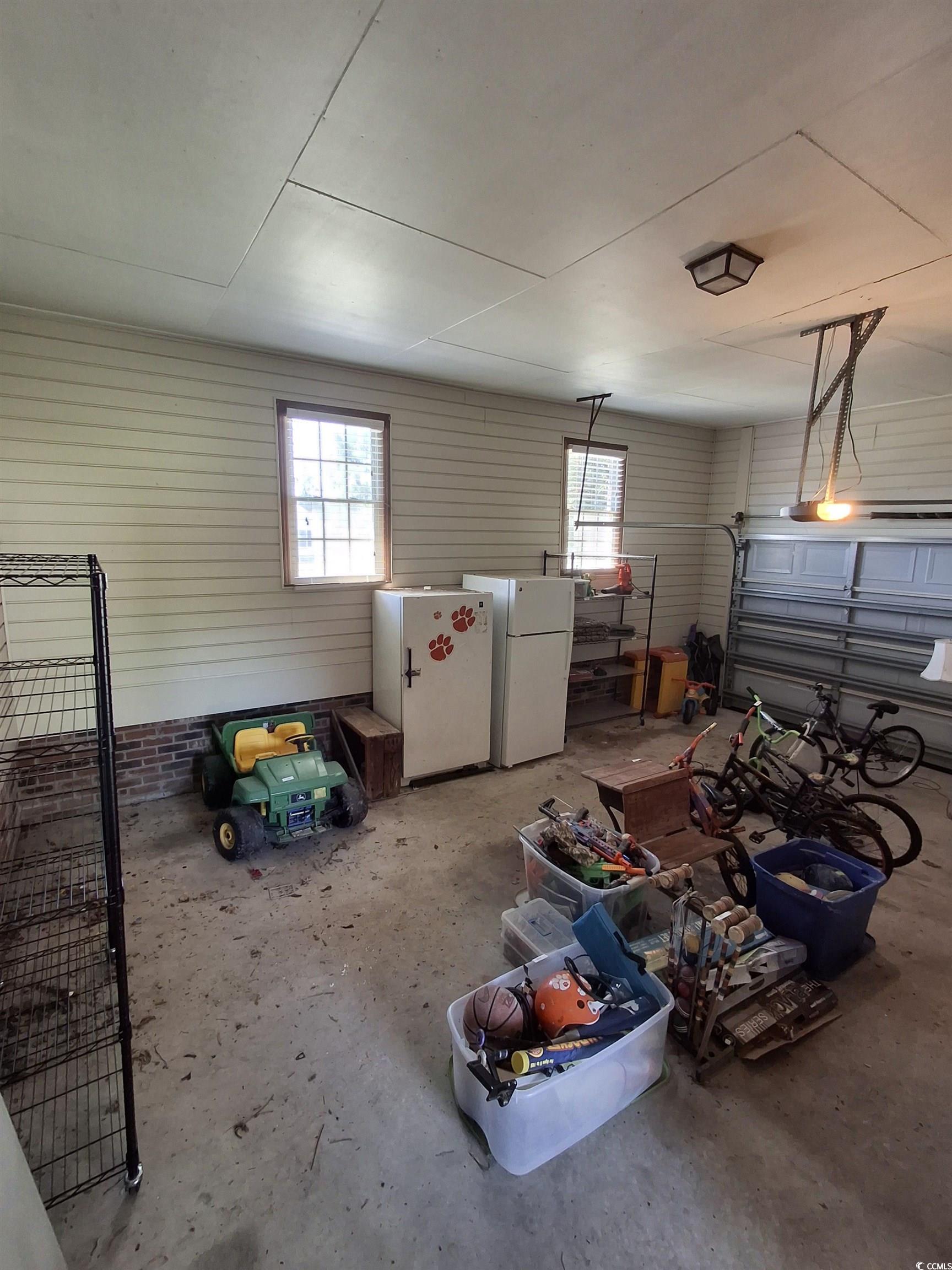 410 Devon Road Marion, SC 29571 - Photo 21 of 38 Garage with white fridge and freestanding refriger