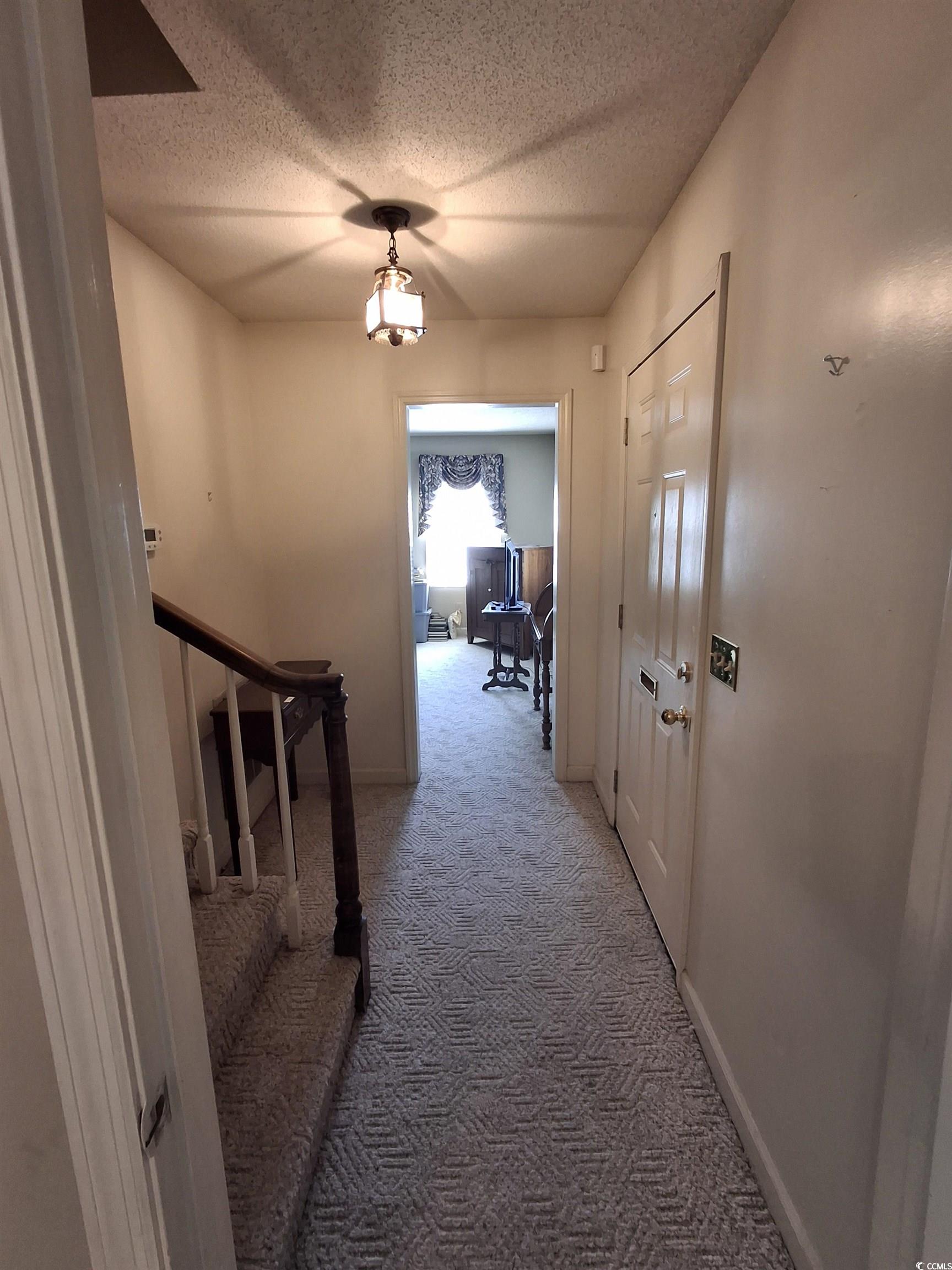 410 Devon Road Marion, SC 29571 - Photo 25 of 38 Hall featuring carpet, a textured ceiling, and sta