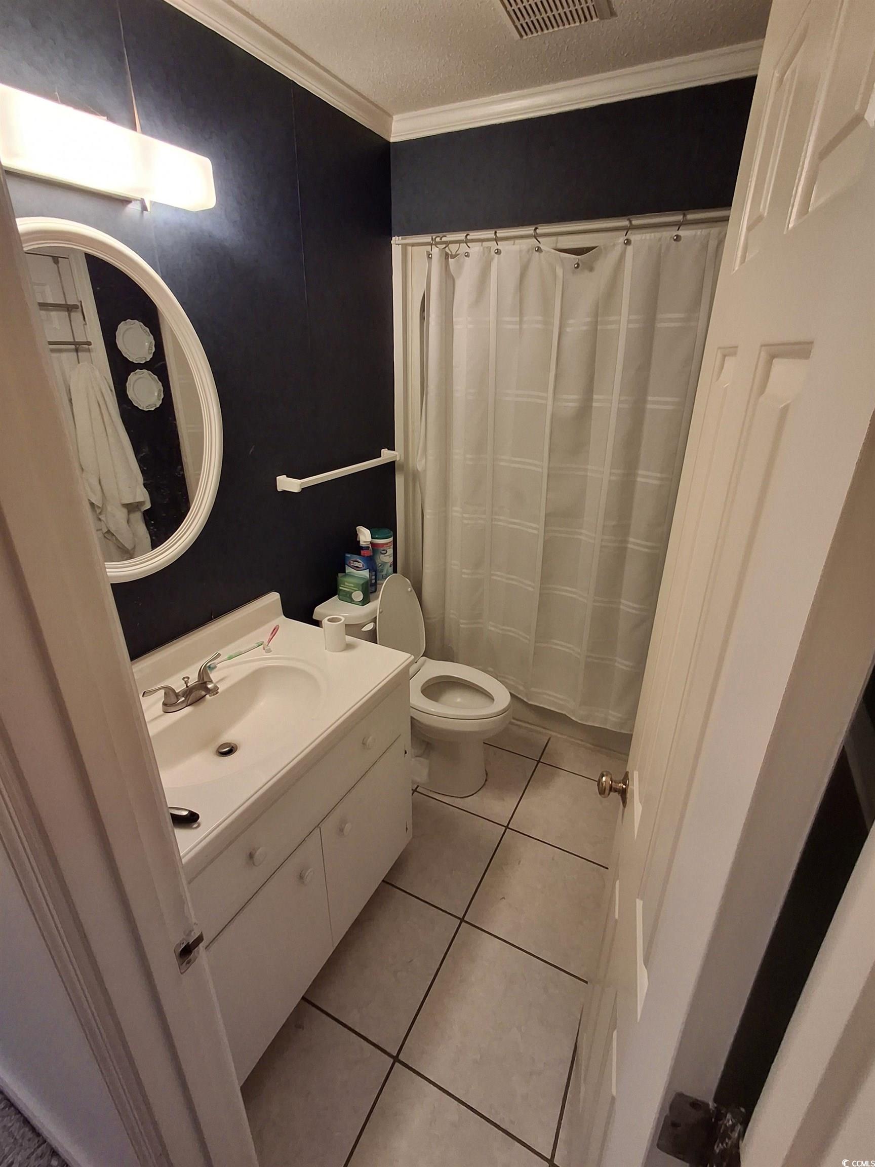 410 Devon Road Marion, SC 29571 - Photo 27 of 38 Full bath featuring crown molding, light tile patt