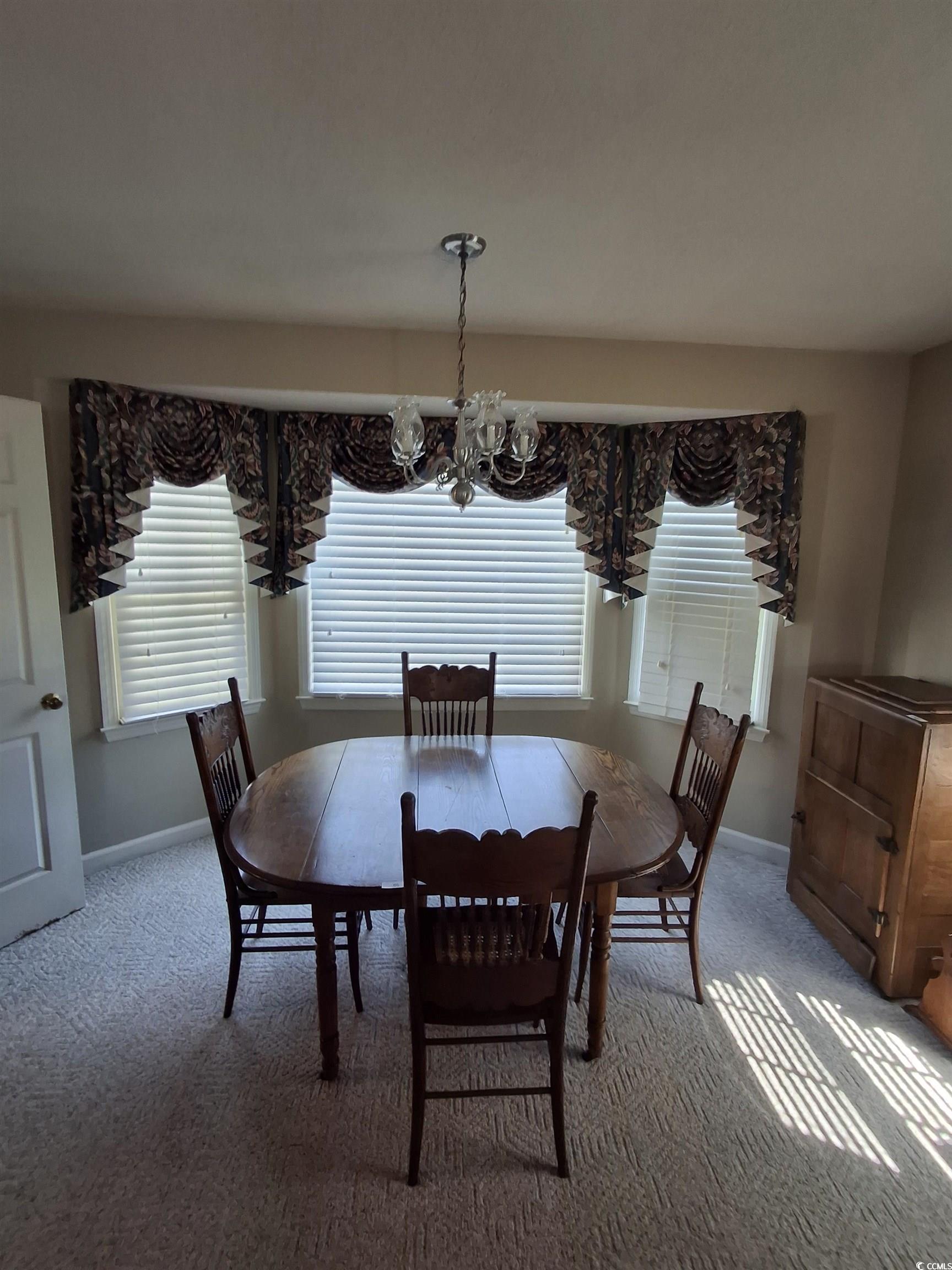 410 Devon Road Marion, SC 29571 - Photo 32 of 38 Dining room featuring carpet flooring and a chande