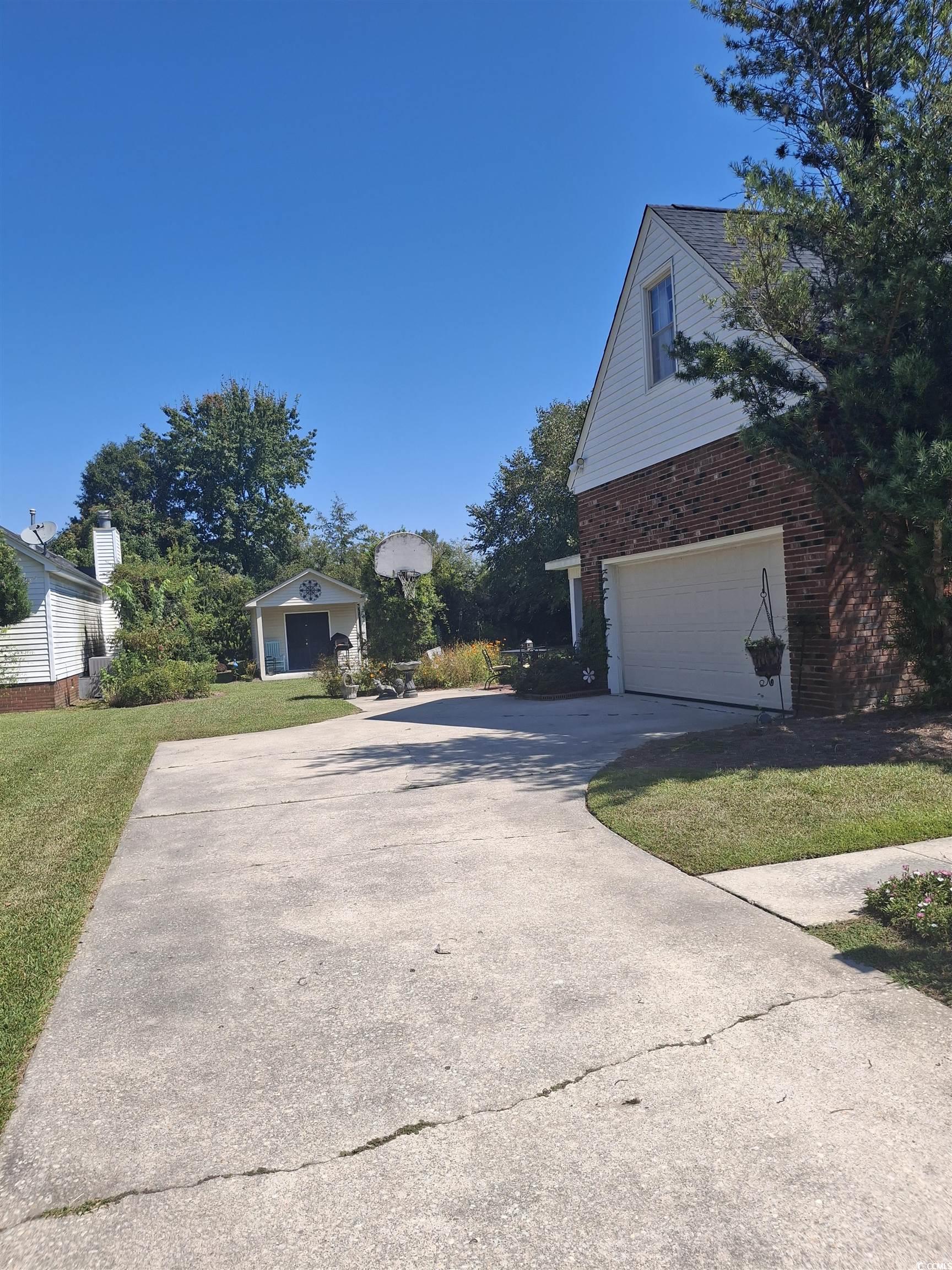 410 Devon Road Marion, SC 29571 - Photo 4 of 38 View of side of home with brick siding, driveway,