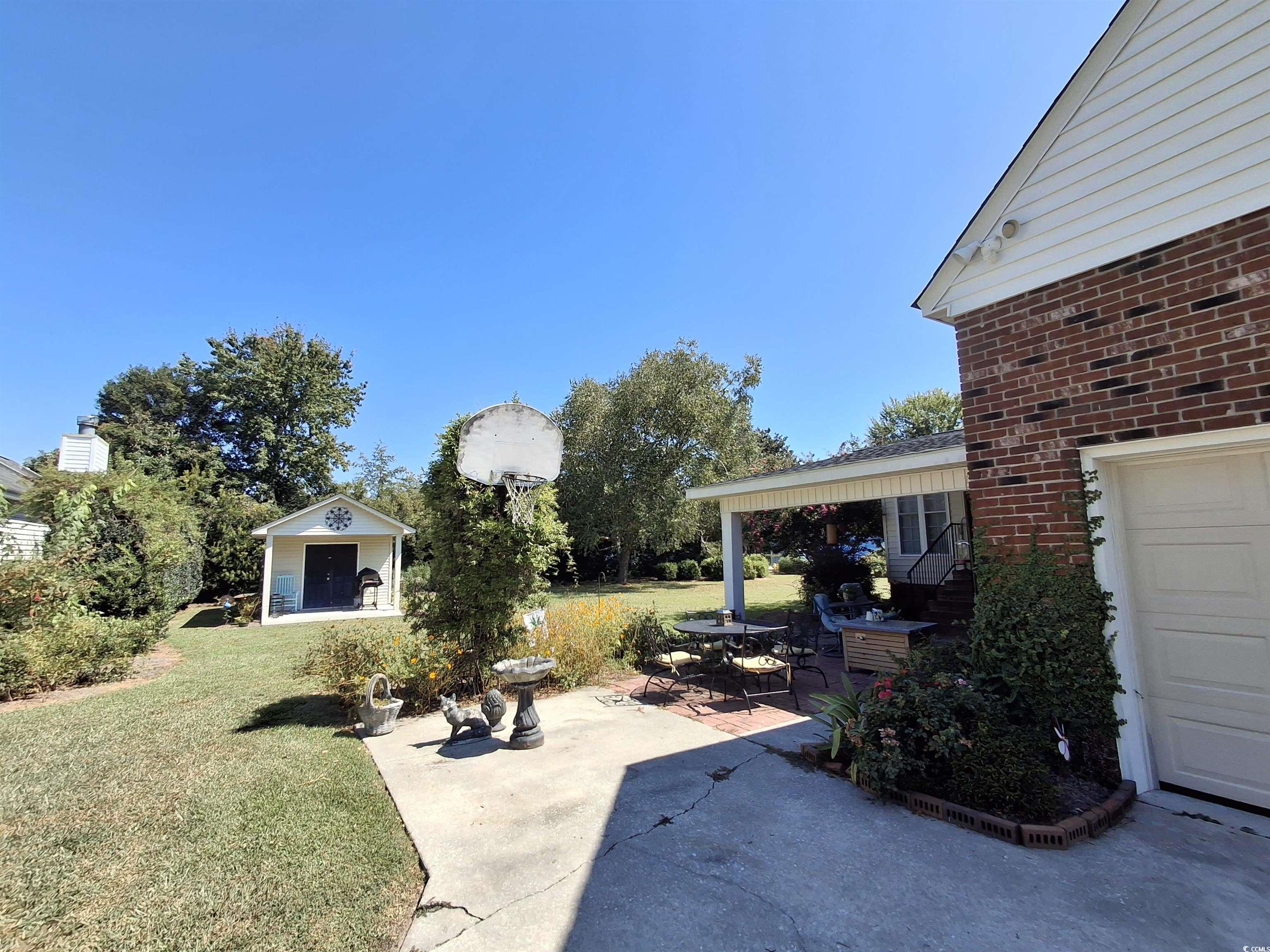 410 Devon Road Marion, SC 29571 - Photo 5 of 38 View of grassy yard featuring a patio area, an out