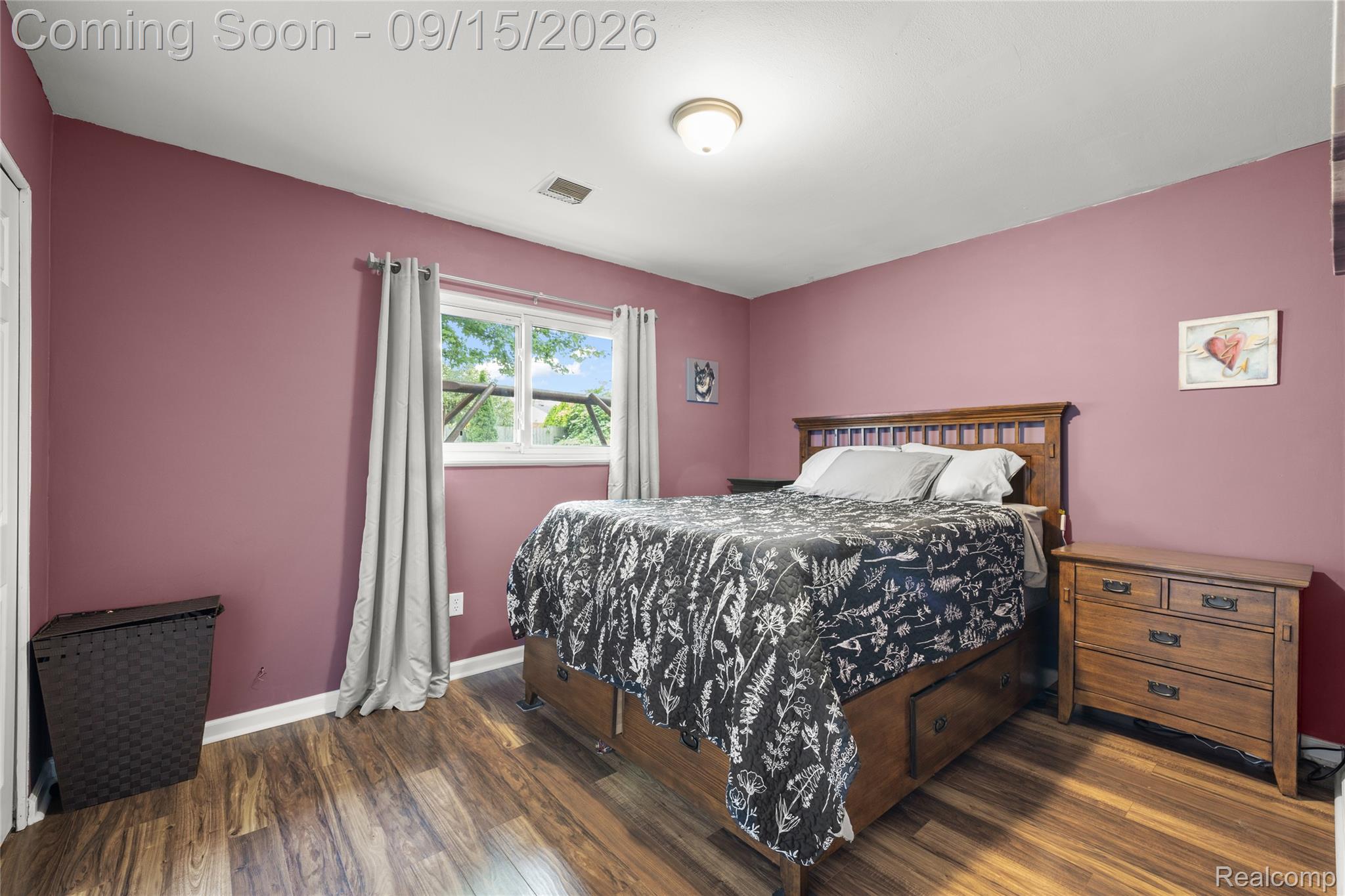 22947 Tuck Road Farmington, MI 48336 - Photo 14 of 34 Wood-finish flooring with a window offering natural light, complemented by a ceiling-mounted light fixture