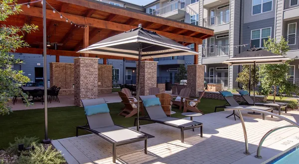 a view of a patio with a table and chairs under an umbrella