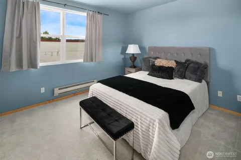 a bedroom with a bed and a lamp