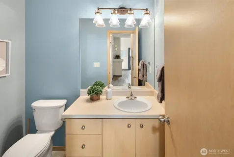 a utility room with stainless steel appliances a sink a stove and a refrigerator