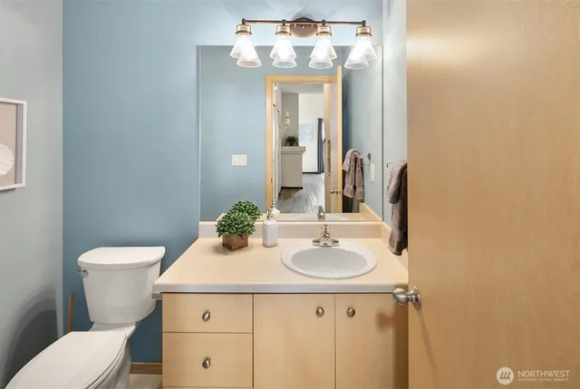 a utility room with stainless steel appliances a sink a stove and a refrigerator
