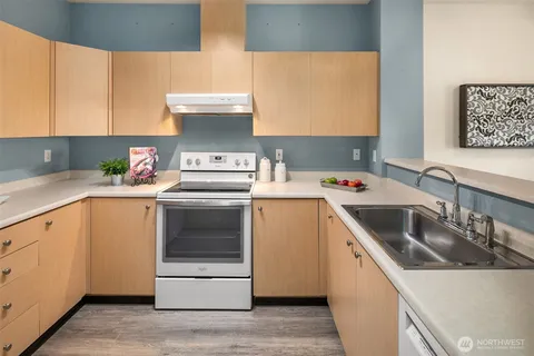 a kitchen with a sink a stove and refrigerator