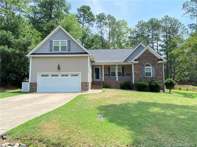 a front view of a house with a yard and garage