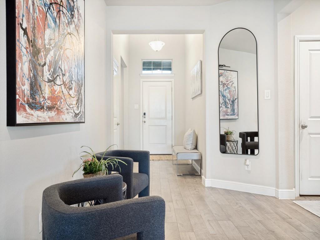 1612 Reed Drive Krum, TX 76249 - Photo 3 of 25 Spacious entryway featuring light wood-finish flooring, white baseboards, and neutral wall tones