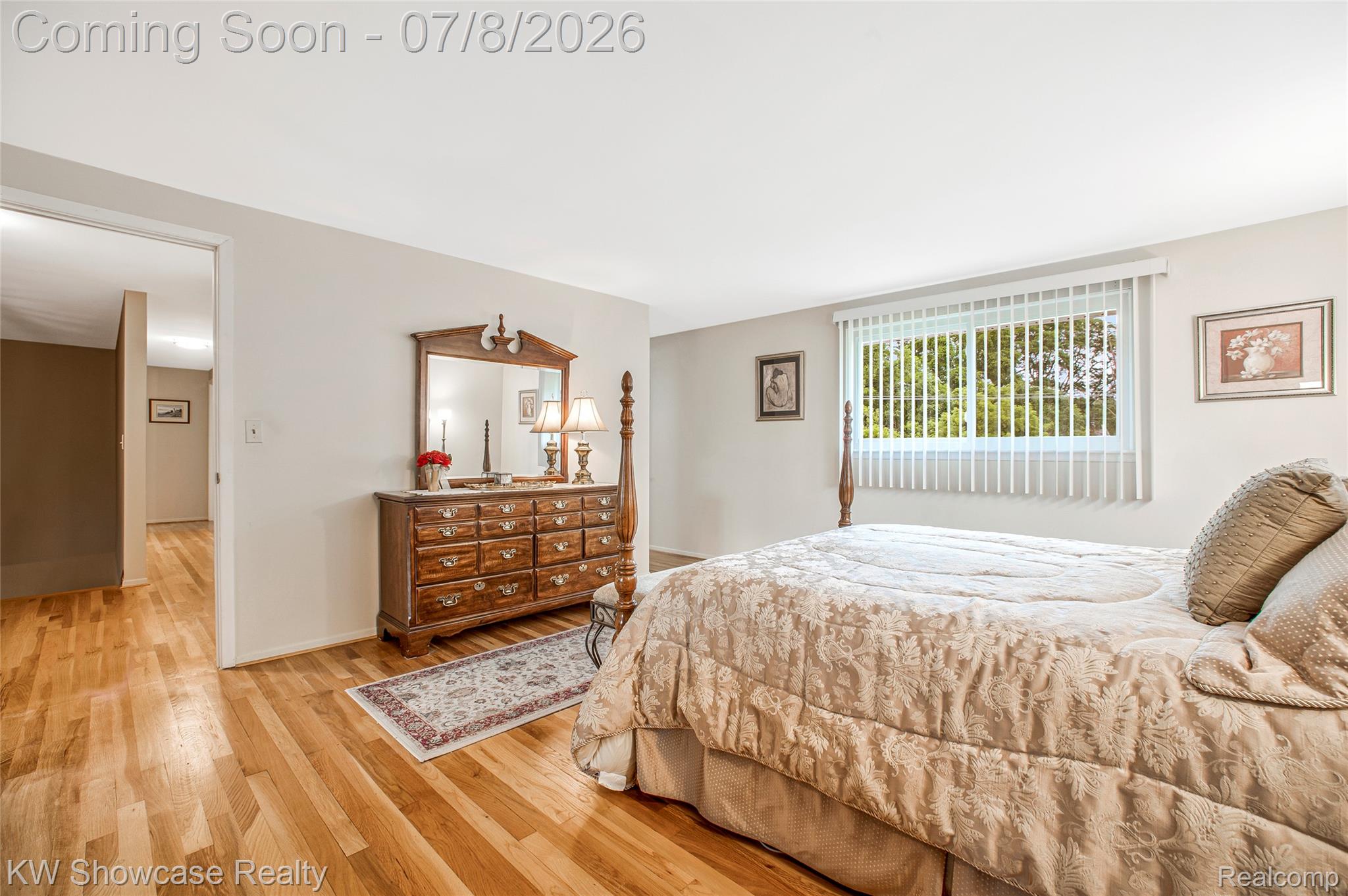16720 Wayne Road Livonia, MI 48154 - Photo 21 of 29 Bright room featuring wood-finish flooring, a large window with vertical blinds, and a wide entryway