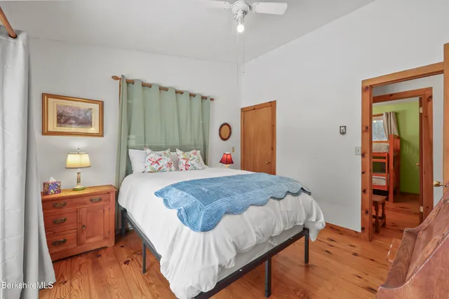 a view of a hallway with furniture and a dresser