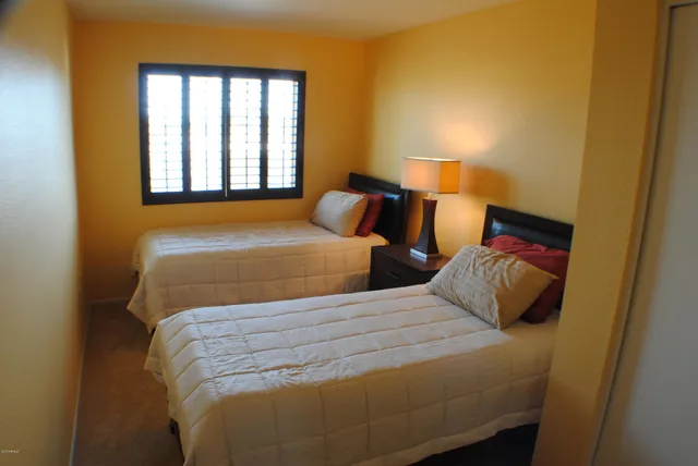 a bedroom with two beds and a window