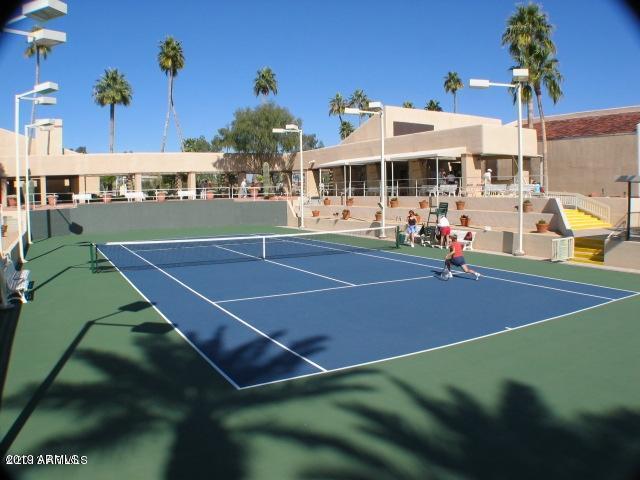 9635 East Palomino Place Sun Lakes, AZ 85248 - Photo 22 of 26 a view of a tennis ground with large trees