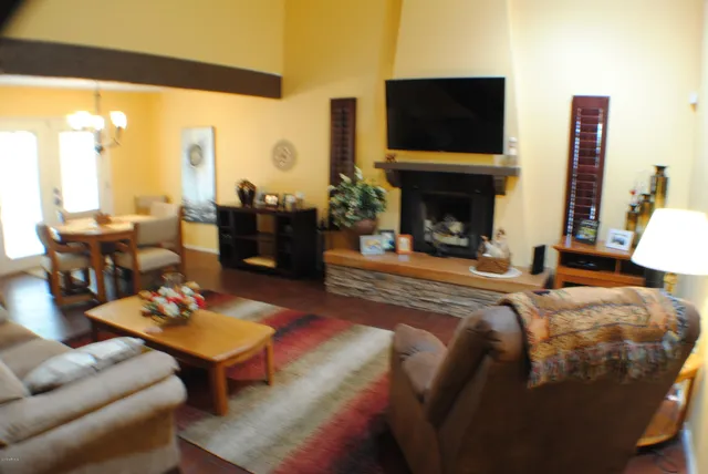 a living room with furniture a fireplace and a flat screen tv