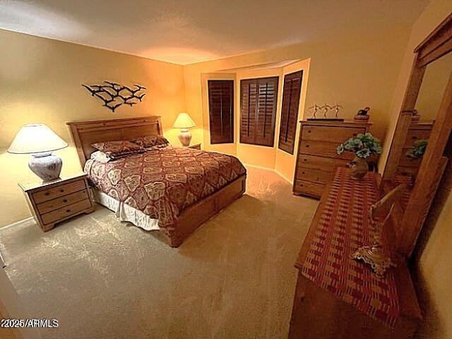 9635 East Palomino Place Sun Lakes, AZ 85248 - Photo 4 of 26 a spacious bedroom with a bed and wooden floor
