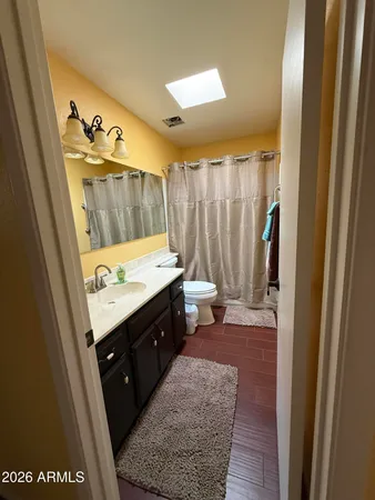 a bathroom with a granite countertop sink a mirror and a bathtub