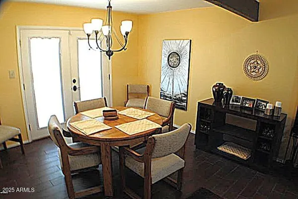 a dining room with furniture and wooden floor