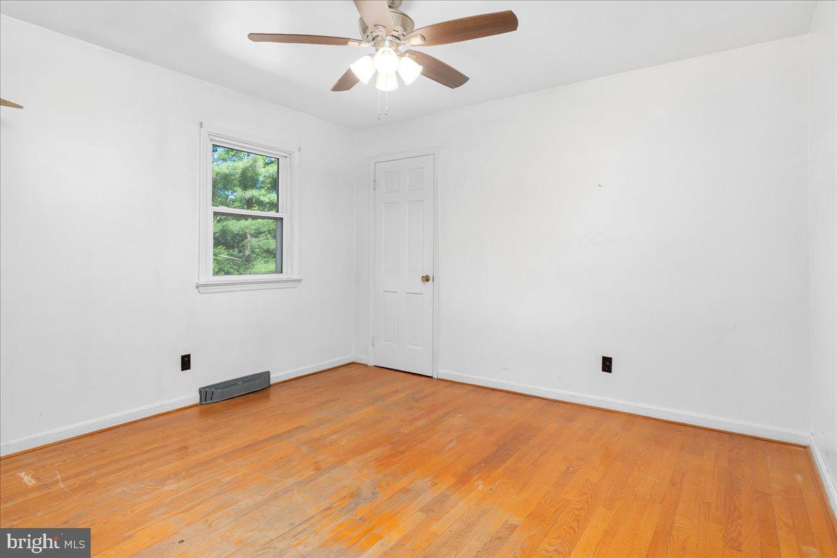 13806 Wolfsville Road Smithsburg, MD 21783 - Photo 16 of 35 an empty room with a window and a fan