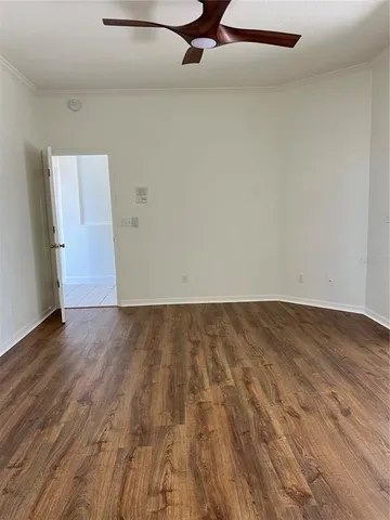 a view of a room with wooden floor and a sink