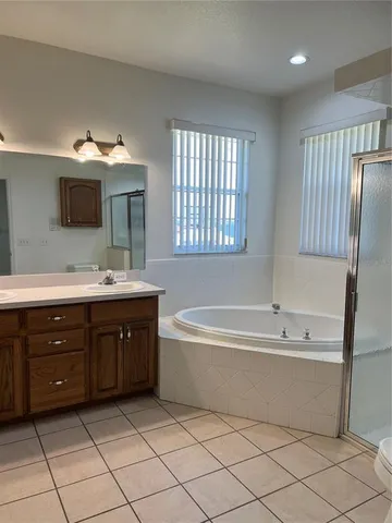 a spacious bathroom with a double vanity sink mirror and