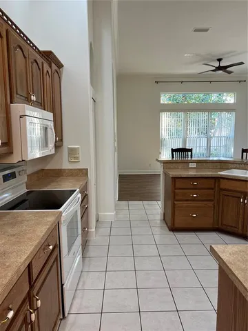 a room with a large window and cabinets