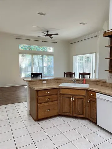 a kitchen with a table chairs and a refrigerator