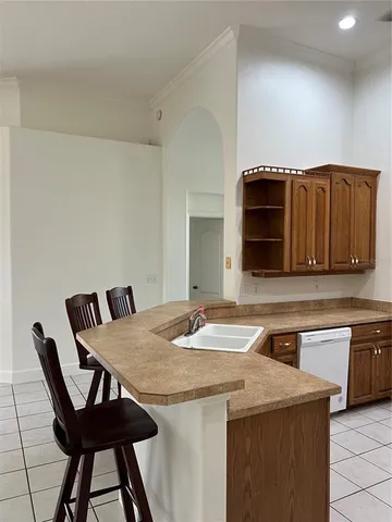 a kitchen with stainless steel appliances kitchen island granite countertop a refrigerator a stove and a sink