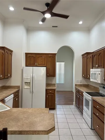 a kitchen with stainless steel appliances granite countertop a stove refrigerator and microwave