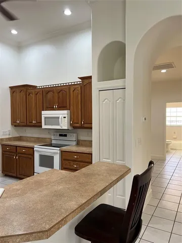 a kitchen with stainless steel appliances granite countertop a refrigerator and a stove top oven