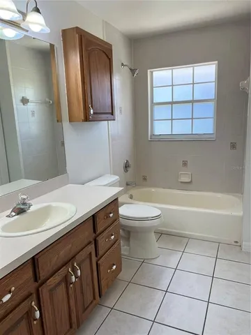 a bathroom with a sink a toilet and bathtub